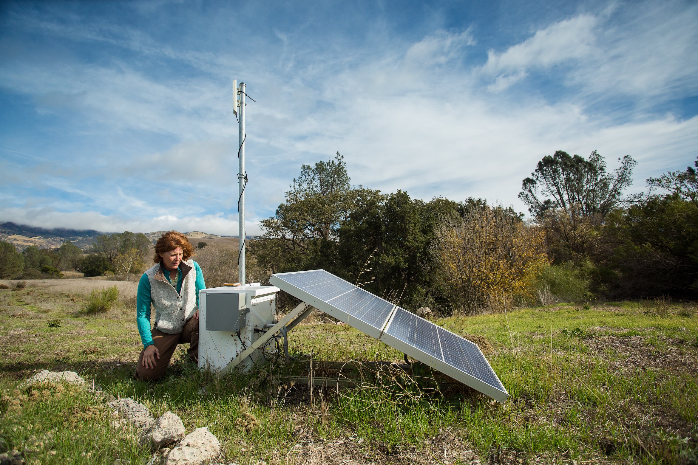 A woman working on a solar panel at the Sedgewick Reserve